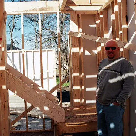 Jim checking out our newly framed house.