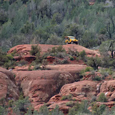 A yellow Jeep high atop the Red Rocks of Sedona.