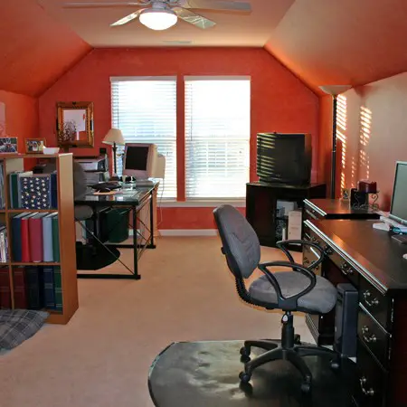 Bonus room painted cinnamon orange with a faux treatment.