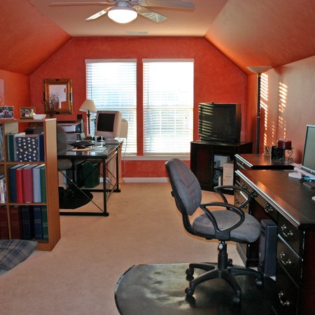 Bonus room painted cinnamon orange with a faux treatment.