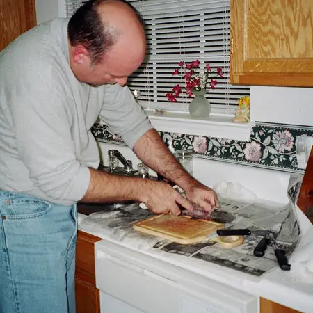 Jim cleaning fish in our kitchen.