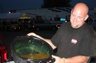 Jim dumping used-up oil and sludge that was drained from the racecar at the end of the night.