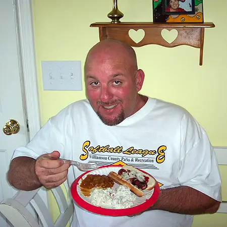 Jim enjoying a plate of cookout-food.