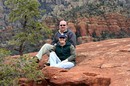 Jim and Lynnette sitting on the red rock on the Broken Arrow trail in Sedona Arizona.