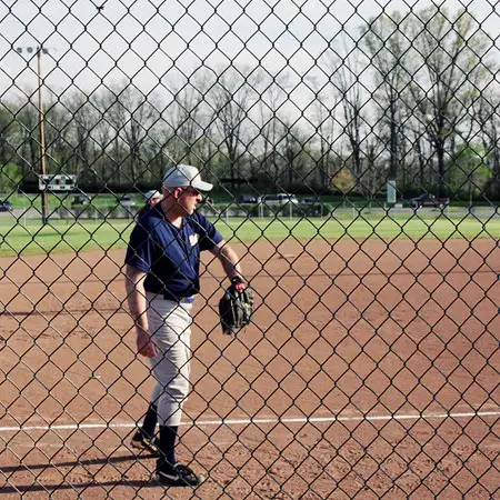 Photo of Jim warming up for softball before the game.