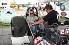 This is Johnny getting firsthand instruction from Terry McMillen on how to start the car using the clutch.