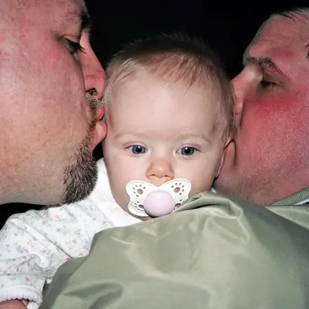 Jim and Mike kissing on Karly.