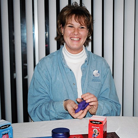 Lynnette sculpting something out of clay in the Cranium board game.