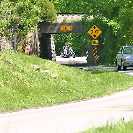 Narrow one-lane bridge under railroad tracks in Nashville, Tennessee.