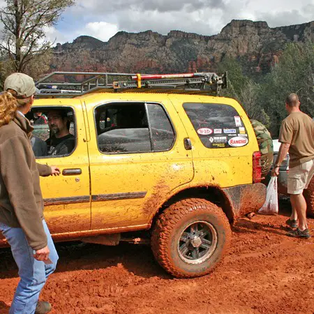 Fellow offroaders making Red Rock t-shirts in the red mud that resulted from the afternoon rain showers.