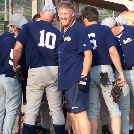 Jim's softball team forming a huddle prior to the game.