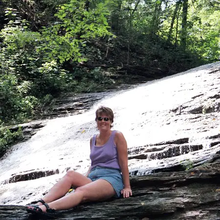 Lynnette taking a break on the edge of a waterfall.